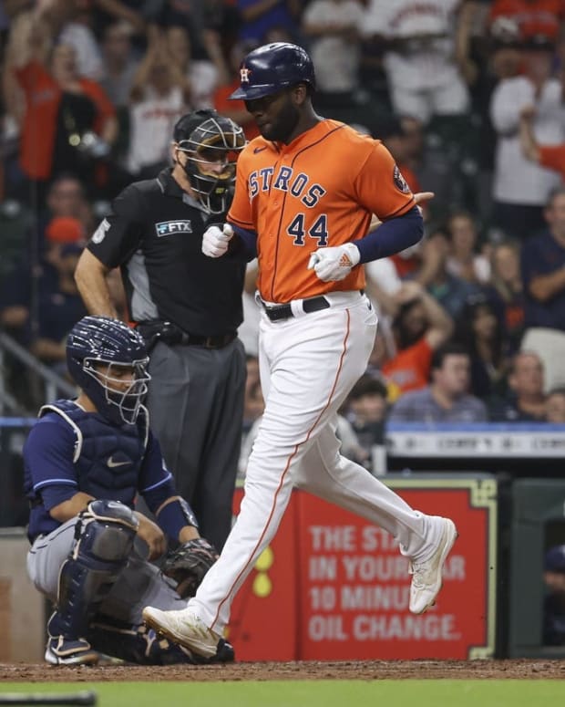 Sep 30, 2022; Houston, Texas, USA; Houston Astros designated hitter Yordan Alvarez (44) scores a run past Tampa Bay Rays catcher Francisco Mejia (21) on an RBI single by first baseman Yuli Gurriel (not pictured) during the fourth inning at Minute Maid Park. Mandatory Credit: Troy Taormina-USA TODAY Sports